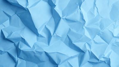 The primary subject of the image is a blue paper with a pattern of folded edges. The setting is a blue background, and the visual style appears to be a digital art or illustration. The colors and mood of the image are predominantly blue, creating a calm and serene atmosphere.