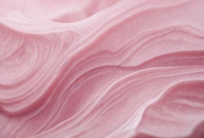 The primary subject of the image is a pink, flowing, and swirling pattern. The setting is a pink background, which adds to the overall visual style. The image appears to be a digital art or illustration, showcasing the artist's creativity and skill in designing the flowing pattern. The colors and mood of the image are predominantly pink, creating a warm and inviting atmosphere.