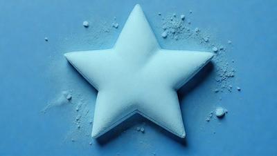 The primary subject of the image is a white star-shaped object, which is the main focus of the image. The setting is a blue background, which creates a contrasting and visually appealing environment. The visual style of the image is a combination of photo and digital art, as it appears to be a close-up of the star-shaped object. The colors in the image are predominantly white and blue, giving the image a clean and calm atmosphere.