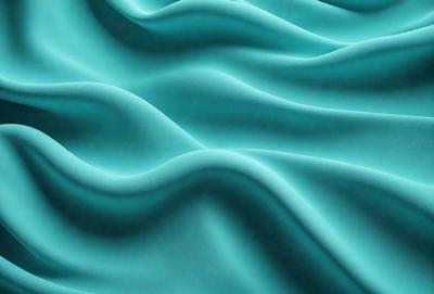The primary subject of the image is a blue fabric, which appears to be a piece of cloth or a curtain. The setting is a blue background, which complements the blue fabric. The visual style is a close-up of the fabric, showcasing its texture and details. The colors and mood of the image are predominantly blue, creating a calm and serene atmosphere.
