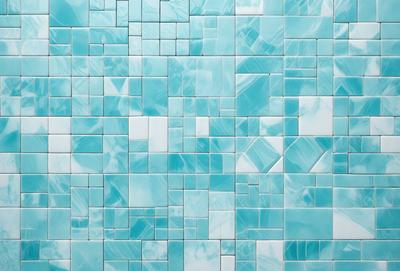 The primary subject of the image is a blue and white tile wall. The setting is a bathroom, as indicated by the blue and white tiles. The visual style is a close-up of the tiles, showcasing their intricate design. The dominant colors are blue and white, creating a calm and soothing atmosphere.