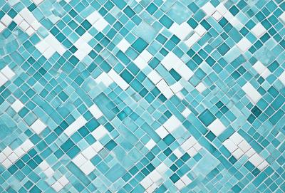 The primary subject of the image is a blue and white mosaic tile pattern. The setting is a wall with a blue and white tile design. The visual style is a close-up of the tile pattern, showcasing the intricate details of the design. The colors and mood of the image are predominantly blue and white, creating a clean and elegant atmosphere.
