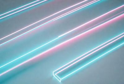 The primary subject of the image is a row of neon lights, which are illuminated and create a vibrant and colorful scene. The setting is a white background, which provides a clean and minimalist environment for the neon lights. The visual style of the image is a combination of digital art and illustration, as the neon lights are depicted in a stylized and artistic manner. The colors and mood of the image are predominantly blue and pink, giving the scene a lively and ener