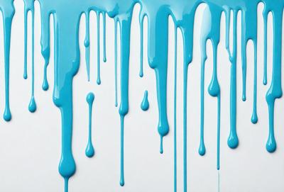 The primary subject of the image is a blue liquid, possibly paint or a similar substance, dripping down a white surface. The setting appears to be a white wall, and the visual style is a close-up of the dripping liquid. The colors and mood of the image are predominantly blue, creating a calm and serene atmosphere.