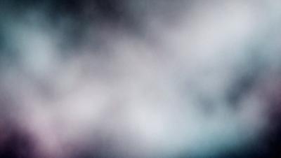 The primary subject of the image is a cloudy sky. The setting is a cloudy background, and the visual style is a photo. The colors and mood of the image are predominantly blue and gray, creating a somewhat moody atmosphere.