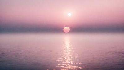 The primary subject of the image is a sunset, with the sun setting over a body of water. The setting is a calm and serene environment, with the sun's rays reflecting off the water, creating a beautiful and peaceful atmosphere. The visual style of the image is a photo, capturing the natural beauty of the sunset and the water. The colors and mood of the image are predominantly warm and soothing, with the sun's hues and the water's tranquility creating a sense