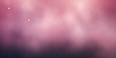 The primary subject of the image is a pink background with a purple hue. The setting appears to be a cloudy sky, creating a moody atmosphere. The visual style of the image is a photo, capturing the natural light and colors of the sky. The dominant colors in the image are pink and purple, creating a warm and calming mood.