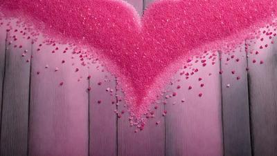 The primary subject of the image is a heart-shaped pink cloud made of sugar or cotton, with a purple background. The heart is filled with pink sugar or cotton, giving it a soft and delicate appearance. The setting is a wooden surface, possibly a table or a wall, where the heart-shaped cloud is placed. The visual style of the image is a combination of digital art and illustration, creating a unique and creative representation of the heart. The colors and mood of the image are pre