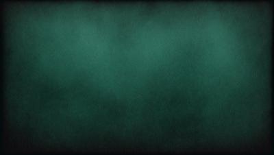 The primary subject of the image is a green background, which appears to be a wall or a piece of fabric. The setting is a dark room, and the visual style is a close-up of the green background. The colors and mood of the image are predominantly dark and moody, with the green background being the main focus.