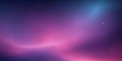 The primary subject of the image is a purple sky with a moon visible in the background. The setting is a cloudy sky, and the visual style appears to be a photo. The dominant colors in the image are purple and pink, creating a serene and calming atmosphere.
