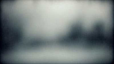 The primary subject of the image is a blurry photo of a car. The setting is a dark, foggy environment, and the visual style appears to be a combination of a photo and a drawing. The dominant colors are black and white, creating a moody atmosphere.