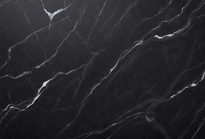 The primary subject of the image is a black marble countertop. The setting is a kitchen, with the countertop being the main focus of the scene. The visual style is a close-up of the marble countertop, showcasing its texture and pattern. The colors and mood of the image are predominantly dark, with the black marble countertop being the main source of contrast.
