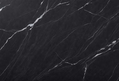 The primary subject of the image is a black marble countertop. The setting is a kitchen, with the countertop being the main focus of the scene. The visual style is a close-up of the marble countertop, showcasing its texture and pattern. The colors and mood of the image are predominantly dark, with the black marble countertop being the main source of contrast.