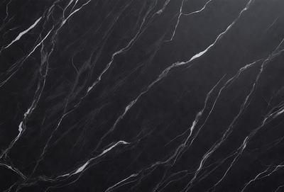 The primary subject of the image is a black marble countertop. The setting is a kitchen, with the countertop being the main focus of the scene. The visual style is a close-up of the marble countertop, showcasing its texture and pattern. The colors and mood of the image are predominantly dark, with the black marble providing a striking contrast against the dark background.