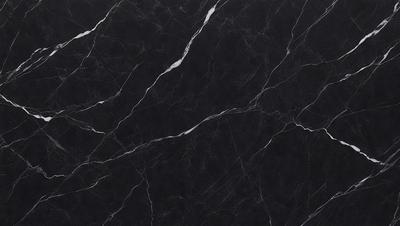 The primary subject of the image is a close-up of a marble countertop. The setting is a kitchen, with the marble countertop being the main focus of the scene. The visual style is a photo, showcasing the natural texture and patterns of the marble. The colors and mood of the image are predominantly black and white, giving it a classic and elegant appearance.