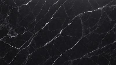 The primary subject of the image is a black marble countertop. The setting is a kitchen, with the countertop being the main focus of the scene. The visual style is a close-up of the marble countertop, showcasing its texture and pattern. The colors and mood of the image are predominantly dark, with the black marble countertop being the main source of contrast.