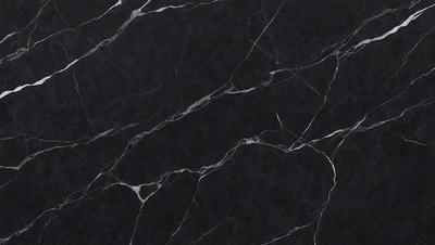The primary subject of the image is a black marble countertop. The setting is a kitchen, with the countertop being the main focus of the scene. The visual style is a close-up of the marble countertop, showcasing its texture and pattern. The colors and mood of the image are predominantly dark, with the black marble countertop being the main source of contrast.