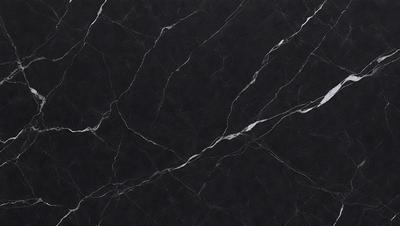 The primary subject of the image is a black marble countertop. The setting is a kitchen, with the countertop being the main focus of the scene. The visual style is a close-up of the marble countertop, showcasing its texture and pattern. The colors and mood of the image are predominantly dark, with the black marble providing a striking contrast against the surrounding environment.