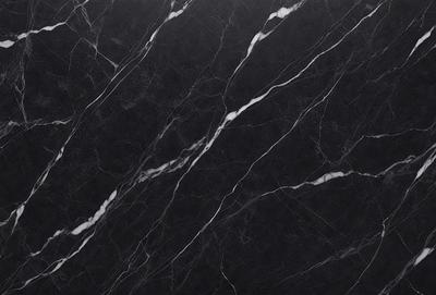The primary subject of the image is a black marble countertop. The setting is a kitchen, with the countertop being the main focus of the scene. The visual style is a close-up of the marble countertop, showcasing its texture and pattern. The colors and mood of the image are predominantly dark, with the black marble countertop being the main source of contrast.