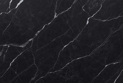 The primary subject of the image is a black marble countertop. The setting is a kitchen, with the countertop being the main focus of the scene. The visual style is a close-up of the marble countertop, showcasing its texture and pattern. The colors and mood of the image are predominantly dark, with the black marble countertop being the main source of contrast.