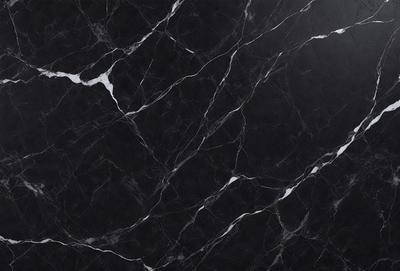 The primary subject of the image is a black marble countertop. The setting is a kitchen, with the countertop being the main focus of the scene. The visual style is a close-up of the marble countertop, showcasing its texture and pattern. The colors and mood of the image are predominantly dark, with the black marble providing a striking contrast against the surrounding environment.