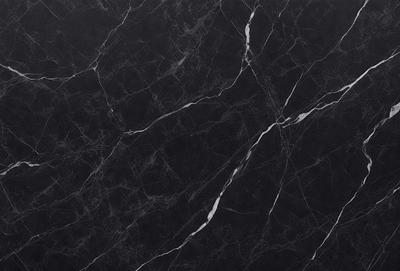 The primary subject of the image is a black marble countertop. The setting is a kitchen, with the countertop being the main focus of the scene. The visual style is a close-up of the marble countertop, showcasing its texture and pattern. The colors and mood of the image are predominantly dark, with the black marble countertop being the main source of contrast.