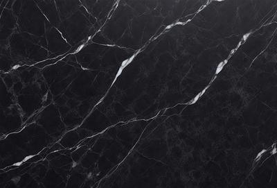 The primary subject of the image is a black marble countertop. The setting is a kitchen, with the countertop being the main focus of the scene. The visual style is a close-up of the marble countertop, showcasing its texture and pattern. The colors and mood of the image are predominantly dark, with the black marble countertop being the main source of contrast.