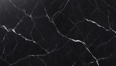 The primary subject of the image is a black marble countertop. The setting is a kitchen, with the countertop being the main focus of the scene. The visual style is a close-up of the marble countertop, showcasing its texture and pattern. The colors and mood of the image are predominantly dark, with the black marble countertop being the main source of contrast.