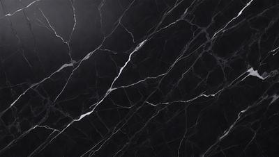 The primary subject of the image is a black marble countertop. The setting is a kitchen, with the countertop being the main focus of the scene. The visual style is a close-up of the marble countertop, showcasing its texture and pattern. The colors and mood of the image are predominantly dark, with the black marble countertop being the main source of contrast.