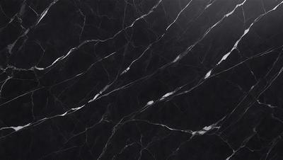 The primary subject of the image is a black marble countertop. The setting is a kitchen, with the countertop being the main focus of the scene. The visual style is a close-up of the marble countertop, showcasing its texture and pattern. The colors and mood of the image are predominantly dark, with the black marble countertop being the main source of contrast.