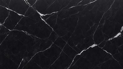 The primary subject of the image is a black marble countertop. The setting is a kitchen, with the countertop being the main focus of the scene. The visual style is a close-up of the marble countertop, showcasing its texture and pattern. The colors and mood of the image are predominantly dark, with the black marble countertop being the main source of contrast.