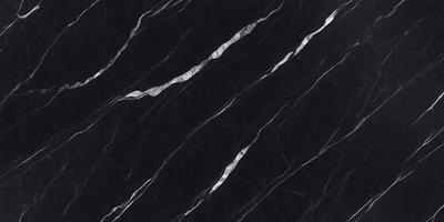 The primary subject of the image is a black marble countertop. The setting is a kitchen, with the countertop being the main focus of the scene. The visual style is a close-up of the marble countertop, showcasing its texture and pattern. The colors and mood of the image are predominantly dark, with the black marble countertop being the main source of contrast.