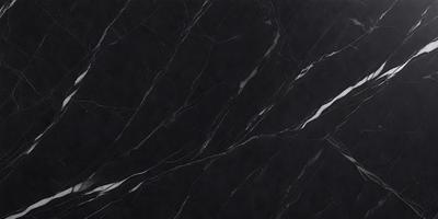 The primary subject of the image is a black marble countertop. The setting is a kitchen, with the countertop being the main focus of the scene. The visual style is a close-up of the marble countertop, showcasing its texture and pattern. The colors and mood of the image are predominantly dark, with the black marble countertop being the main source of contrast.