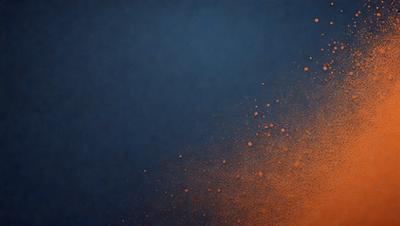 The primary subject of the image is a close-up of a bright orange substance, possibly a spray or a splash, with a blue background. The visual style appears to be a digital art or illustration, as the orange substance is the main focus and the background is a solid color. The colors and mood of the image are vibrant and energetic, with the orange substance standing out against the blue background.