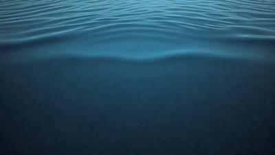 The primary subject of the image is a large body of water, which appears to be a deep blue ocean. The setting is a vast expanse of water, with no visible land or other objects in the background. The visual style of the image is a photo, capturing the natural beauty of the ocean. The colors and mood of the image are serene and tranquil, with the deep blue water evoking a sense of calmness and relaxation.