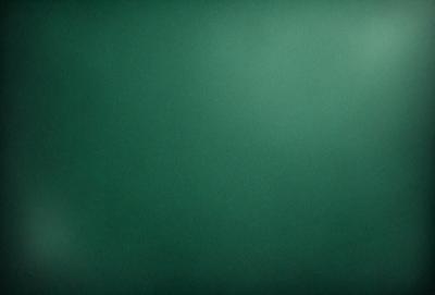 The primary subject of the image is a green background. The setting is a dark room, and the visual style is a photo. The dominant colors are green, and the overall atmosphere is calm and serene.