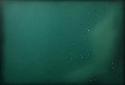 The primary subject of the image is a large body of water, which appears to be a dark green color. The setting is a vast, open space with no visible land or other objects. The visual style of the image is a combination of a photo and a digital art, creating a unique and intriguing atmosphere. The colors and mood of the image are dark and moody, with the green water and the vastness of the space contributing to the overall ambiance.