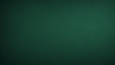 The primary subject of the image is a green background. The setting is a dark room, and the visual style is a photo. The colors and mood of the image are predominantly dark and moody, with the green background being the main focus.