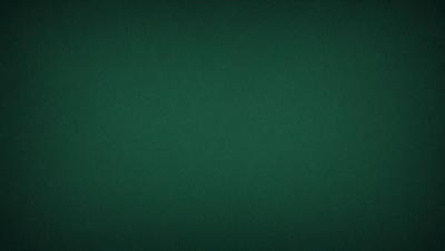 The primary subject of the image is a green background. The setting is a dark room, and the visual style is a photo. The dominant colors are green, and the overall atmosphere is calm and serene.