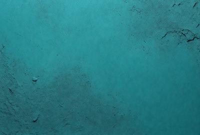 The primary subject of the image is a blue surface, which appears to be a wall or a piece of artwork. The setting is a room with a blue background, and the visual style is a close-up of the blue surface. The colors and mood of the image are predominantly blue, creating a calm and serene atmosphere.