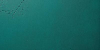 The primary subject of the image is a large, empty blue surface. The setting is a dark blue background, which creates a contrast with the light blue surface. The visual style is a close-up of the blue surface, showcasing its texture and color. The colors and mood of the image are predominantly blue, giving it a calm and serene atmosphere.