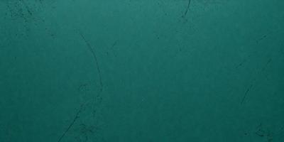 The primary subject of the image is a green background with a few black specks. The setting is a dark room, and the visual style appears to be a photo. The colors and mood of the image are predominantly dark and moody, with the green background providing a subtle contrast.