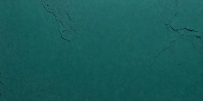 The primary subject of the image is a green surface, which appears to be a wall or a piece of fabric. The setting is indoors, with the green surface being the main focus of the image. The visual style is a close-up of the green surface, showcasing its texture and color. The colors and mood of the image are predominantly green, creating a calm and soothing atmosphere.
