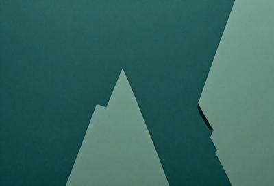 The primary subject of the image is a mountain, which is depicted in a green and white color scheme. The mountain is set against a blue background, giving it a striking appearance. The visual style of the image is a combination of digital art and illustration, creating a unique and eye-catching design. The overall atmosphere of the image is one of adventure and exploration, as the mountain serves as a symbol of nature's beauty and power.