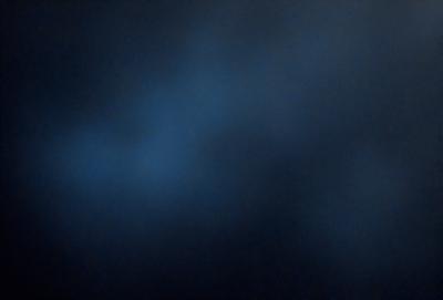 The primary subject of the image is a blue sky with clouds. The setting is a dark, cloudy night, creating a moody atmosphere. The visual style is a photo, capturing the beauty of the night sky. The colors are predominantly blue, with some white clouds, and the mood is serene and contemplative.