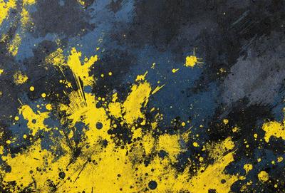 The primary subject of the image is a yellow and blue splattered background. The setting is a dark blue surface, and the visual style appears to be a combination of a photo and digital art. The colors and mood of the image are vibrant and energetic, with the yellow and blue colors creating a lively atmosphere.