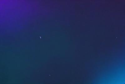The primary subject of the image is the night sky, which is filled with stars. The setting is a dark, starry background, and the visual style is a photo of the night sky. The colors and mood of the image are predominantly dark and serene, with the stars providing a sense of wonder and tranquility.