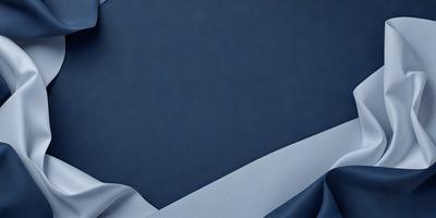 The primary subject of the image is a white sheet of fabric, which is the main object in the scene. The setting is a blue wall, providing a contrasting backdrop for the fabric. The visual style of the image is a photo, capturing the fabric's texture and details. The colors in the image are predominantly blue and white, creating a calm and serene atmosphere.