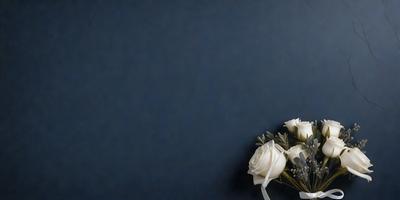 The primary subject of the image is a bouquet of white flowers, which are arranged in a vase. The setting is a blue wall, which serves as the backdrop for the flowers. The visual style is a close-up of the flowers, showcasing their beauty and details. The colors and mood of the image are predominantly white, creating a serene and elegant atmosphere.