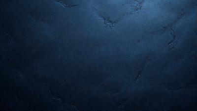 The primary subject of the image is a blue wall with a textured surface. The setting is a room with a blue wall, and the visual style is a close-up of the wall. The dominant colors are blue and grey, creating a calm and serene atmosphere.